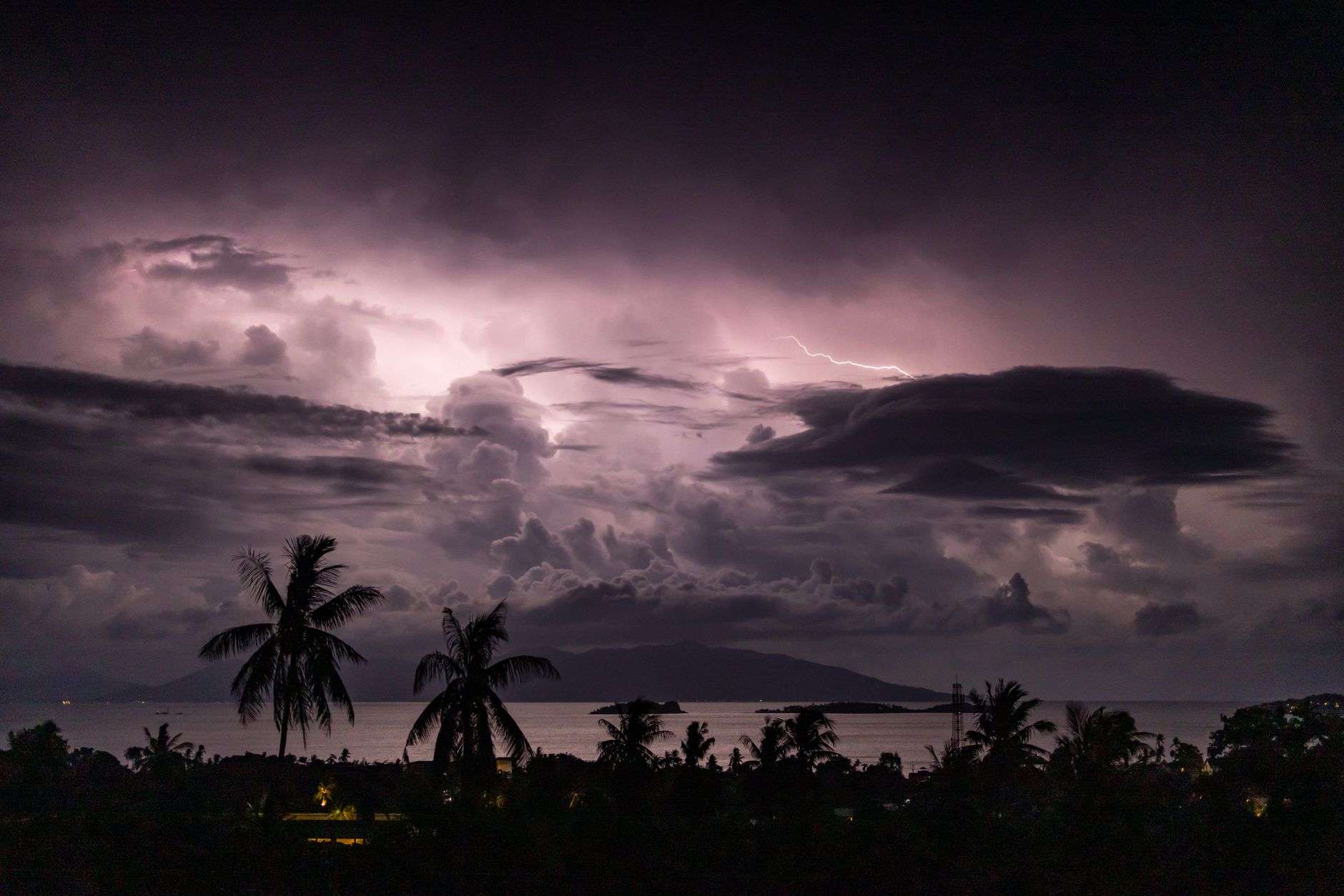 Dark storm clouds gathering over the ocean horizon