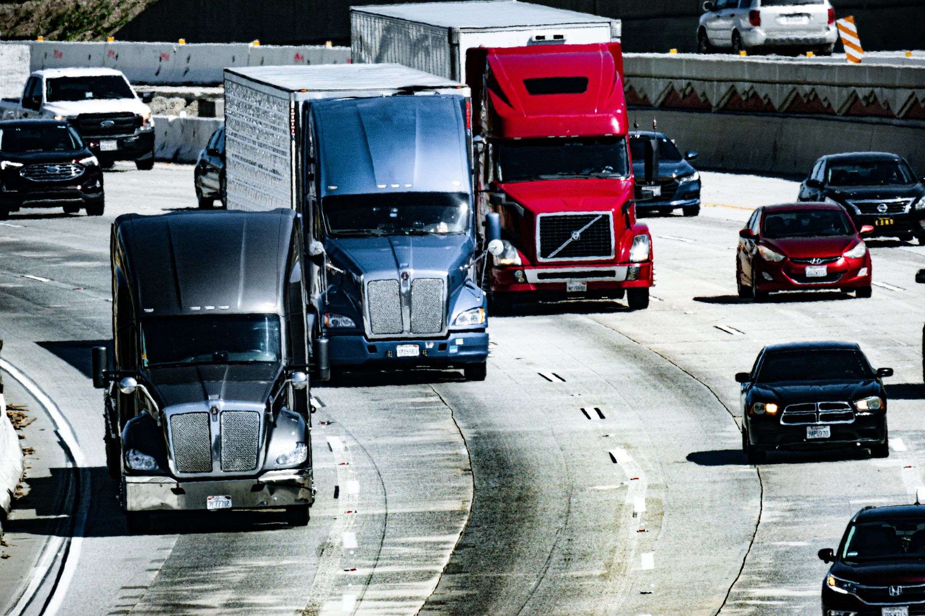 Semi trucks traveling on a rural highway