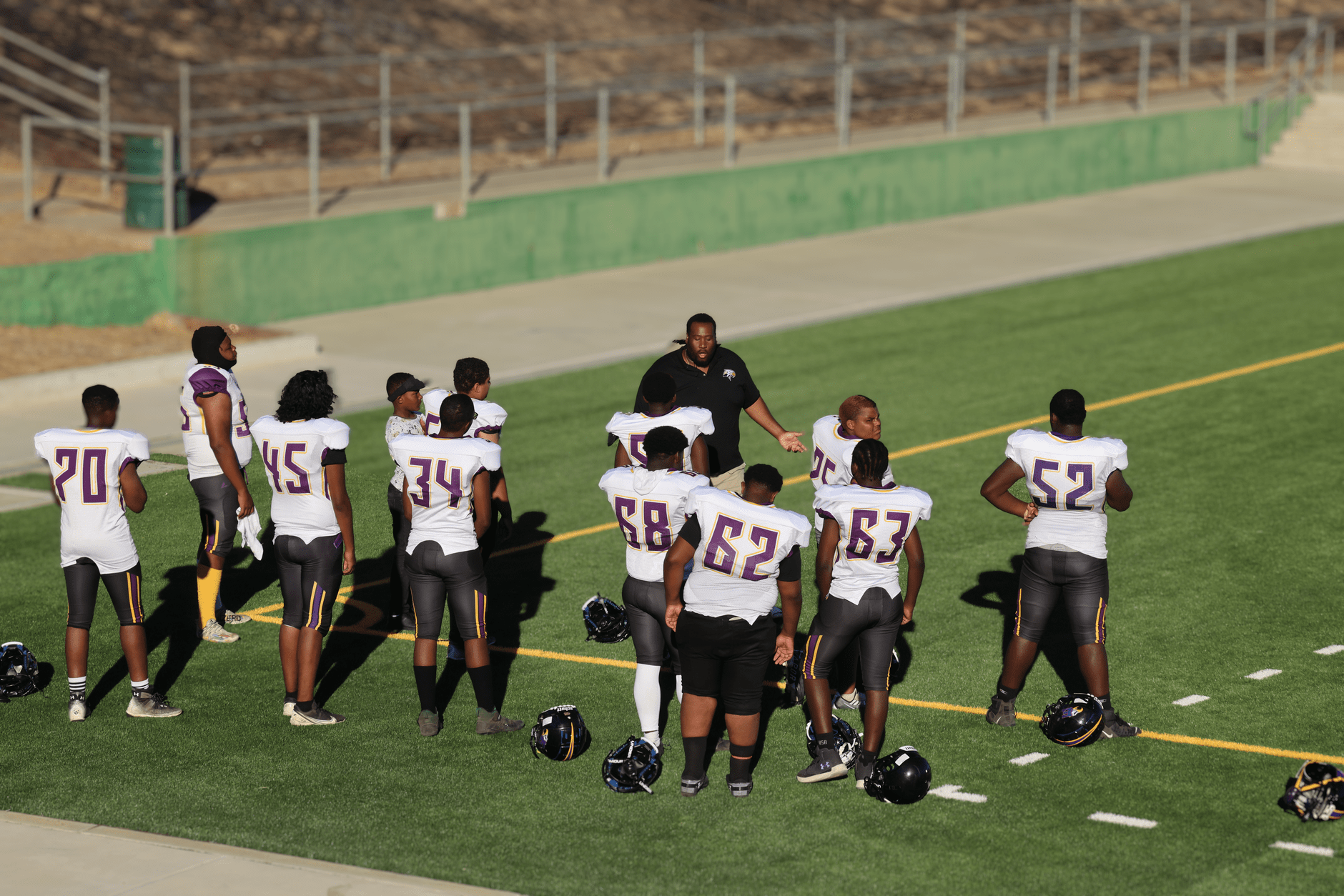 High school football player on the field preparing for a game