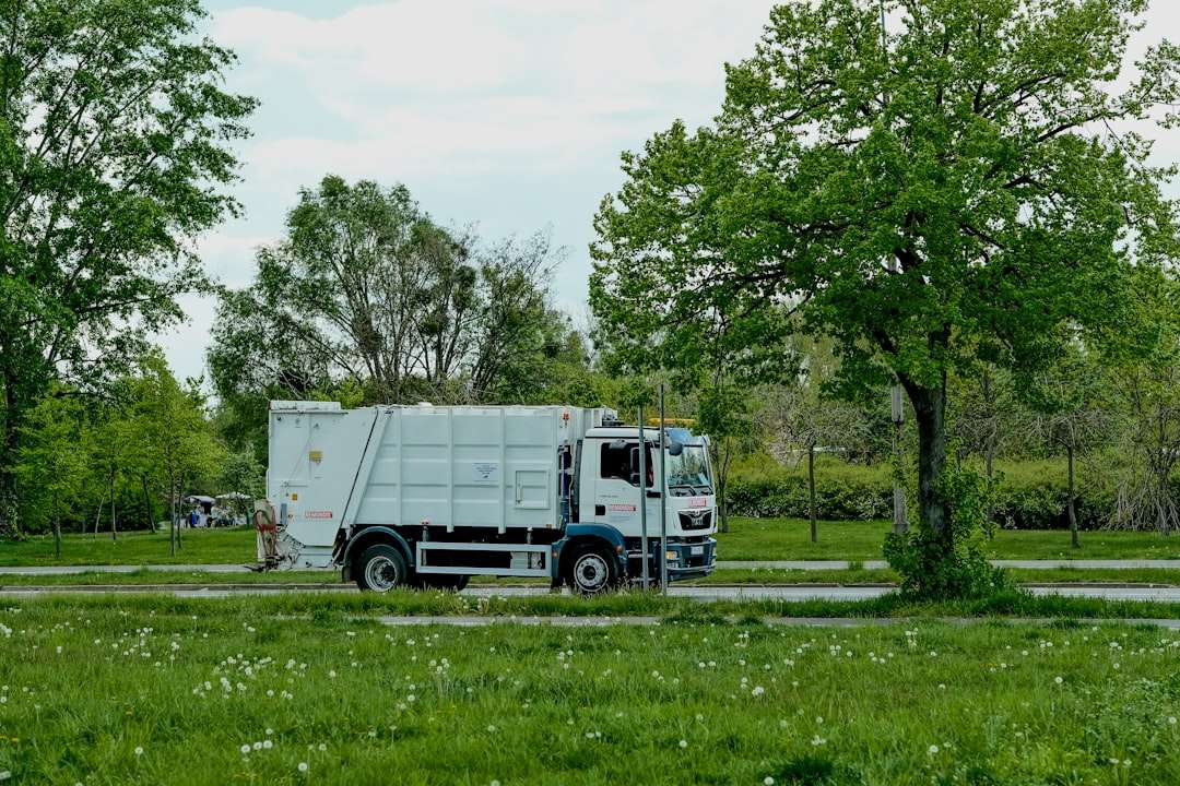 A municipal garbage truck parked on a residential street during a trash collection route