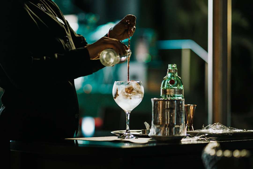 Bartender mixing a craft cocktail behind a restaurant bar