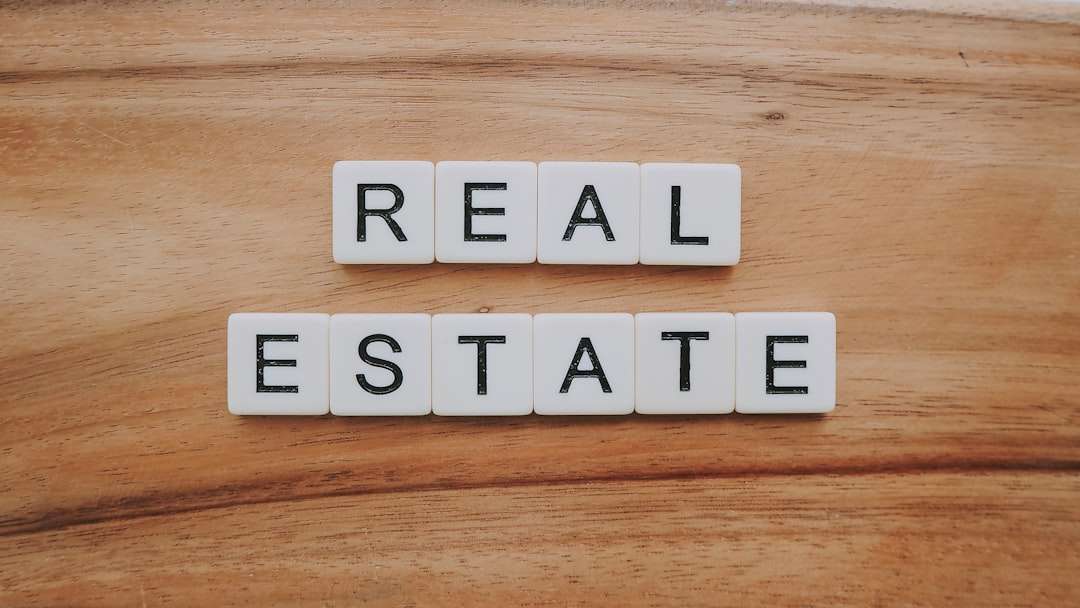 Real estate agent discussing property details at a desk with listing materials