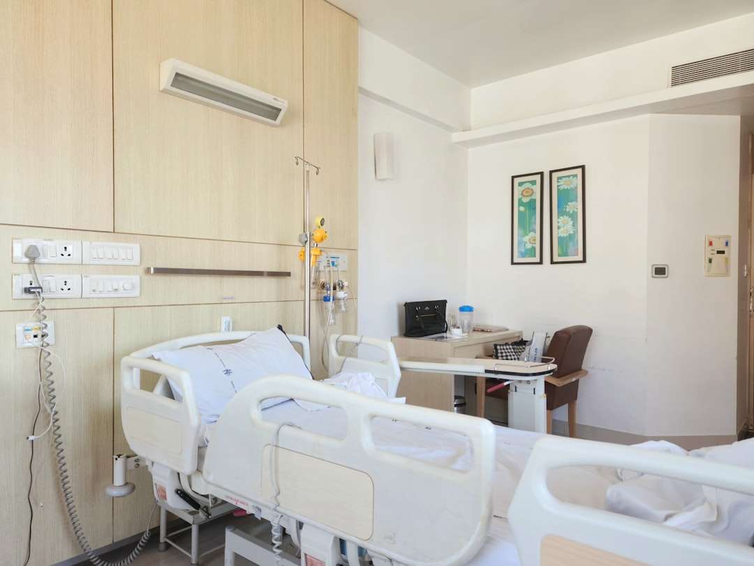 Empty pediatric hospital room with a child's bed and medical equipment