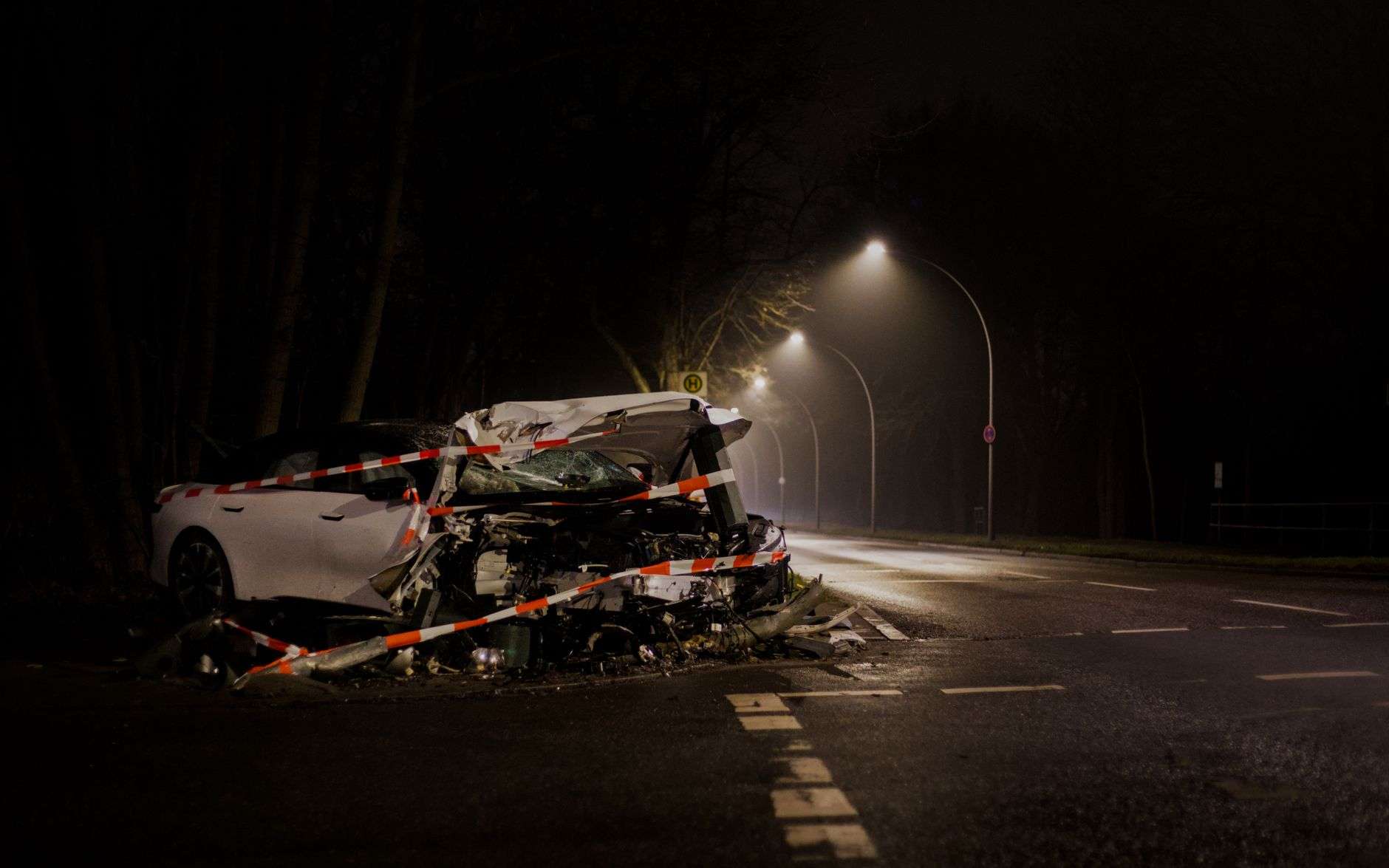 Damaged vehicle at a nighttime crash scene, illustrating a two-vehicle accident