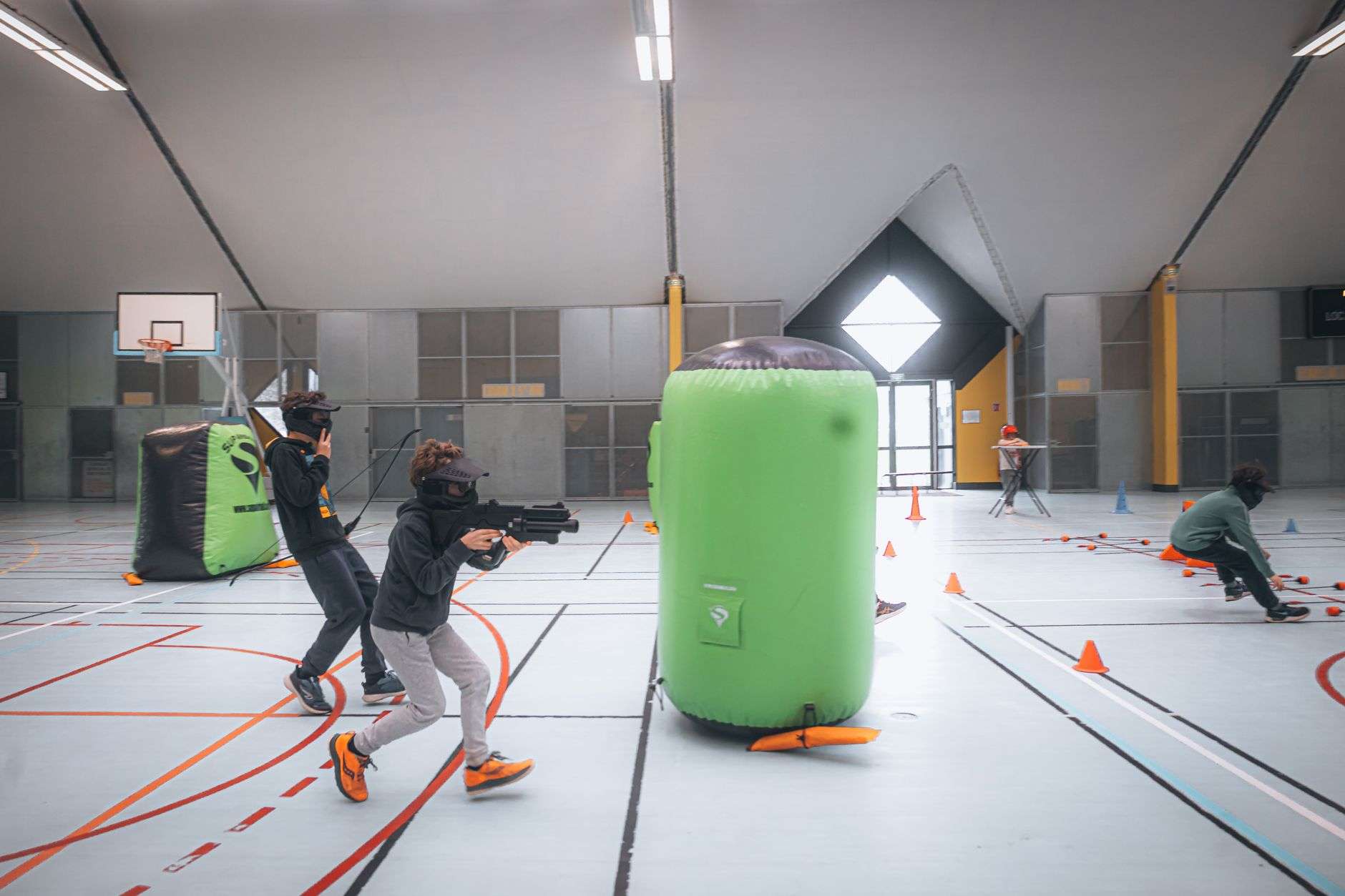 Giant inflatable obstacle course lit up at night for an outdoor party