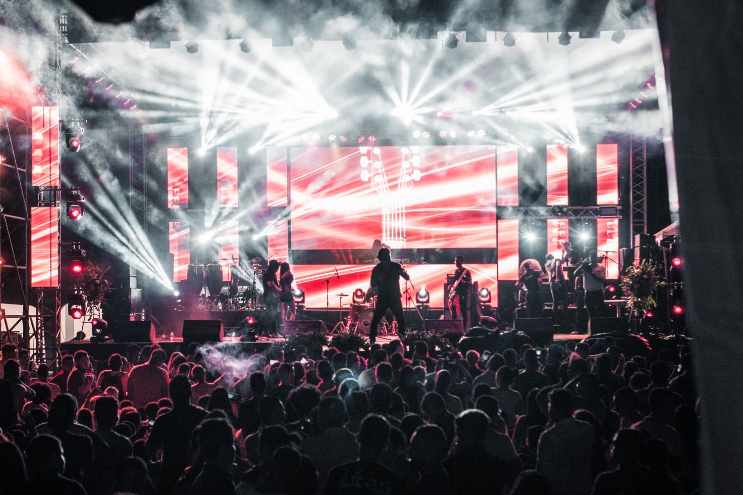 A band performs under colorful stage lights for a club audience