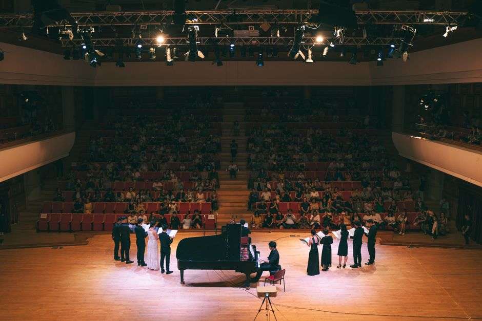 Lit theater stage set for a live musical performance