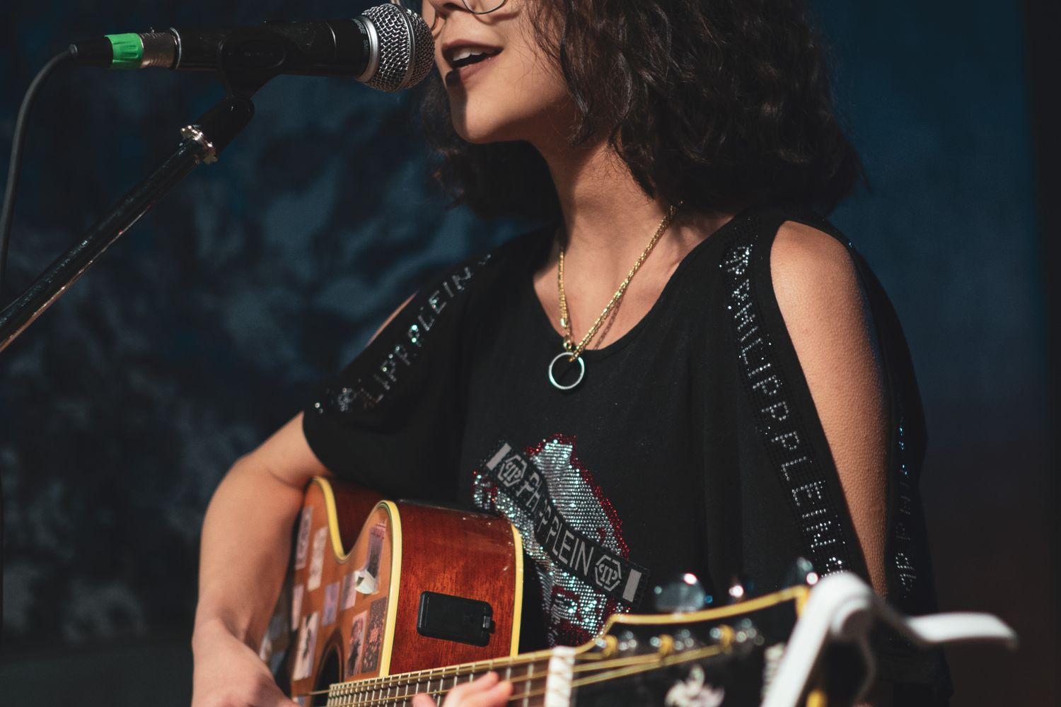 Singer-songwriter performing live with an acoustic guitar