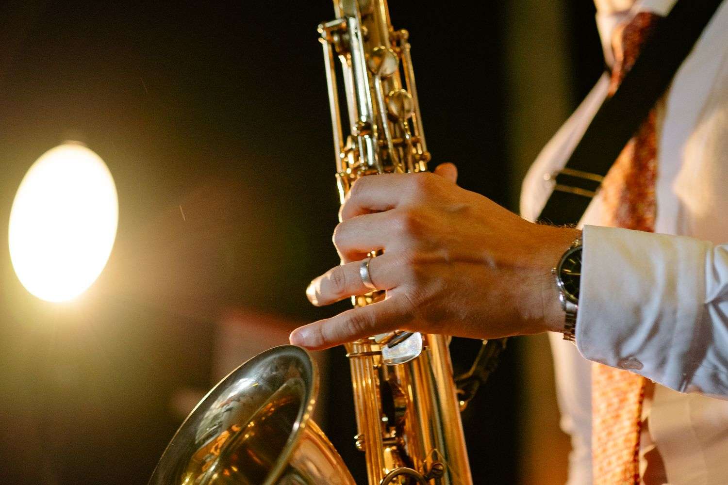 A saxophone player on stage at a music festival