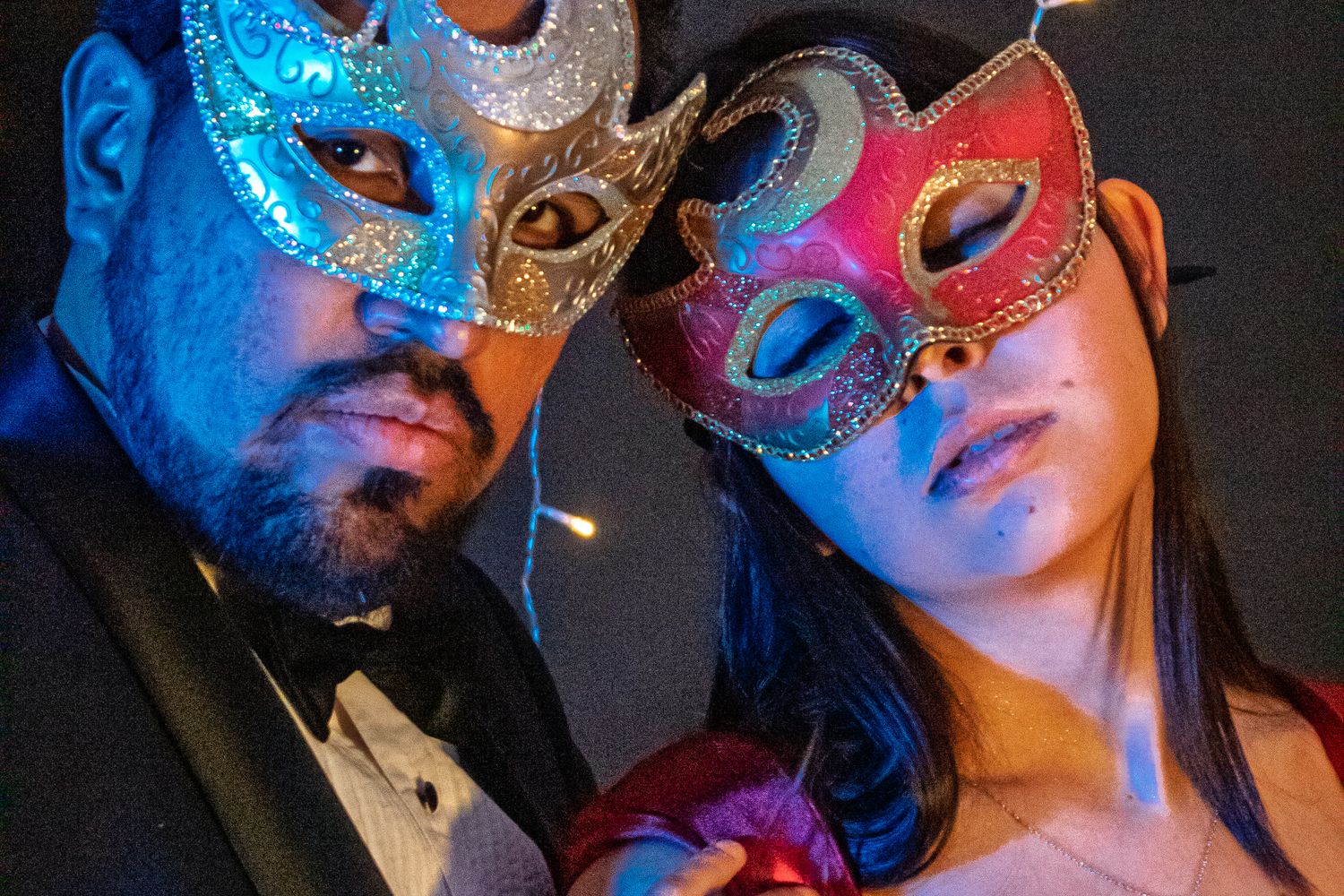 Ornate masquerade masks and formal attire at a Mardi Gras ball celebration