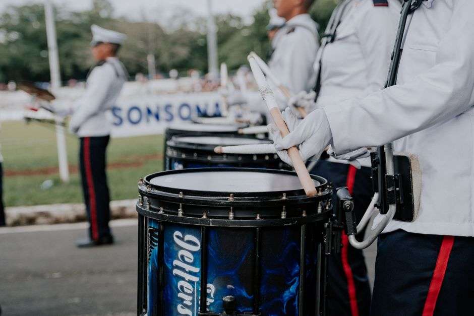 High school marching band members performing on a field