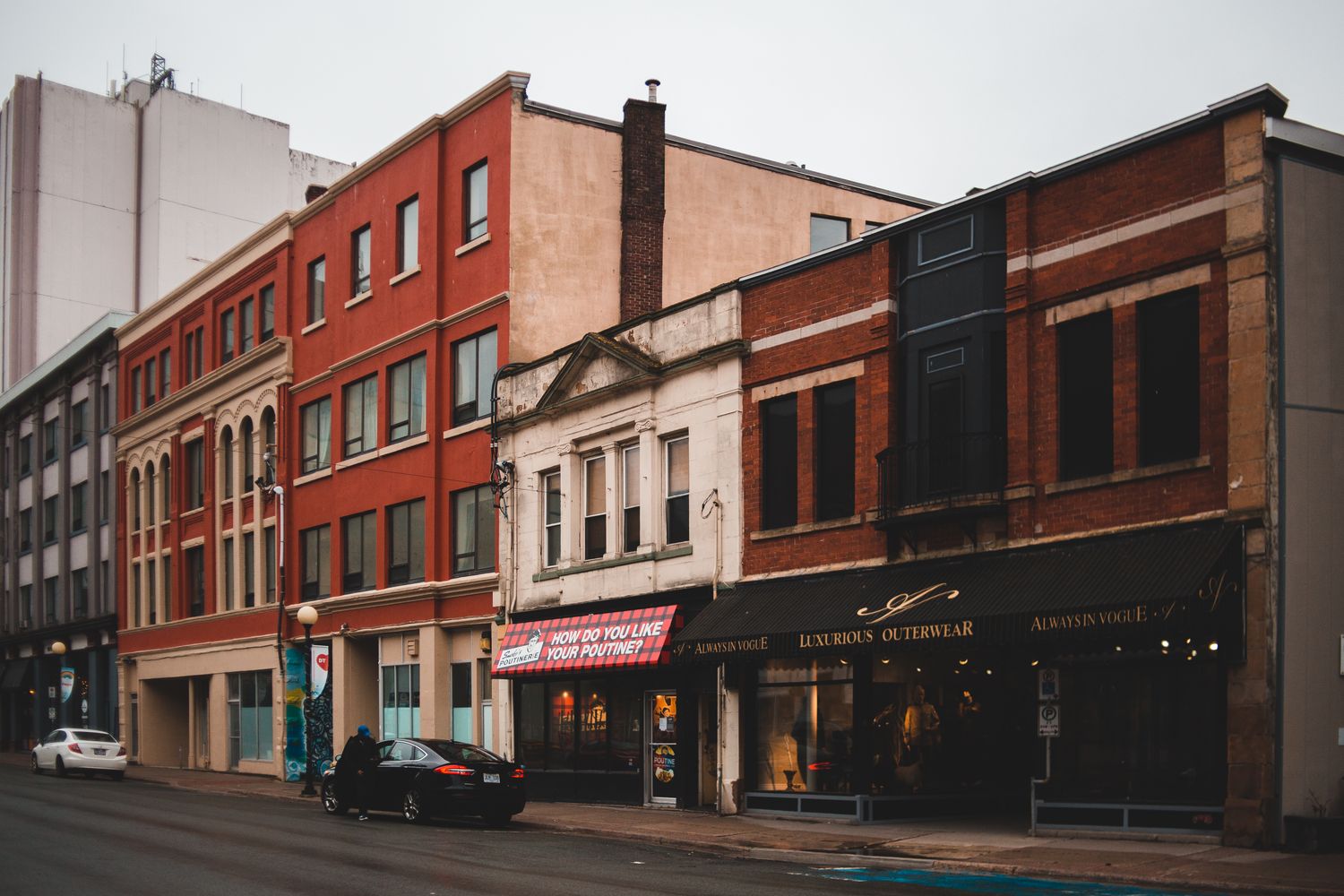 Storefronts and galleries lining a downtown street shopping district