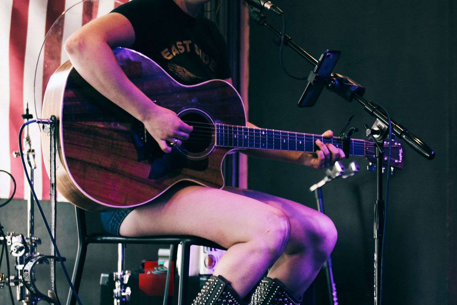 A young female country singer performing with a microphone