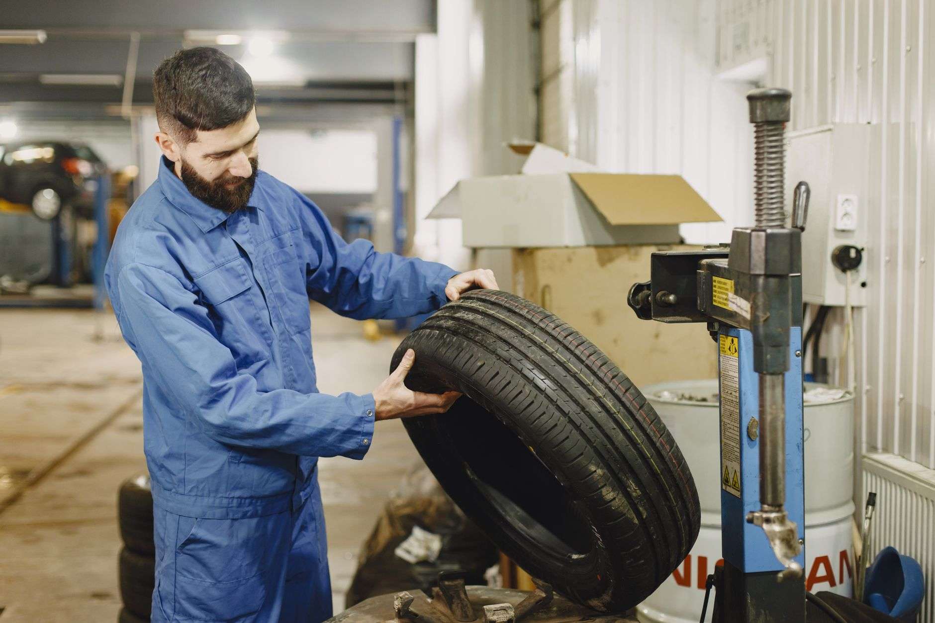 A service bay in an automotive repair shop with tires and equipment