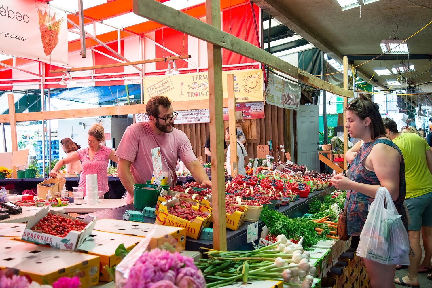 Tables of fresh produce at an outdoor community farmers market