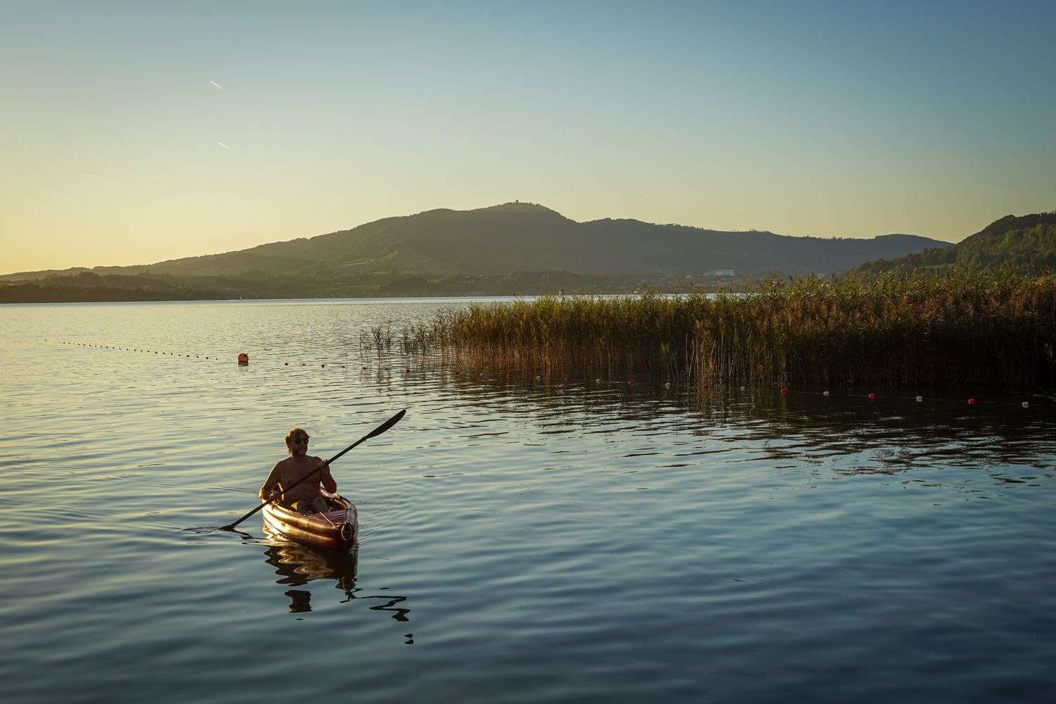 A person kayaking on open water
