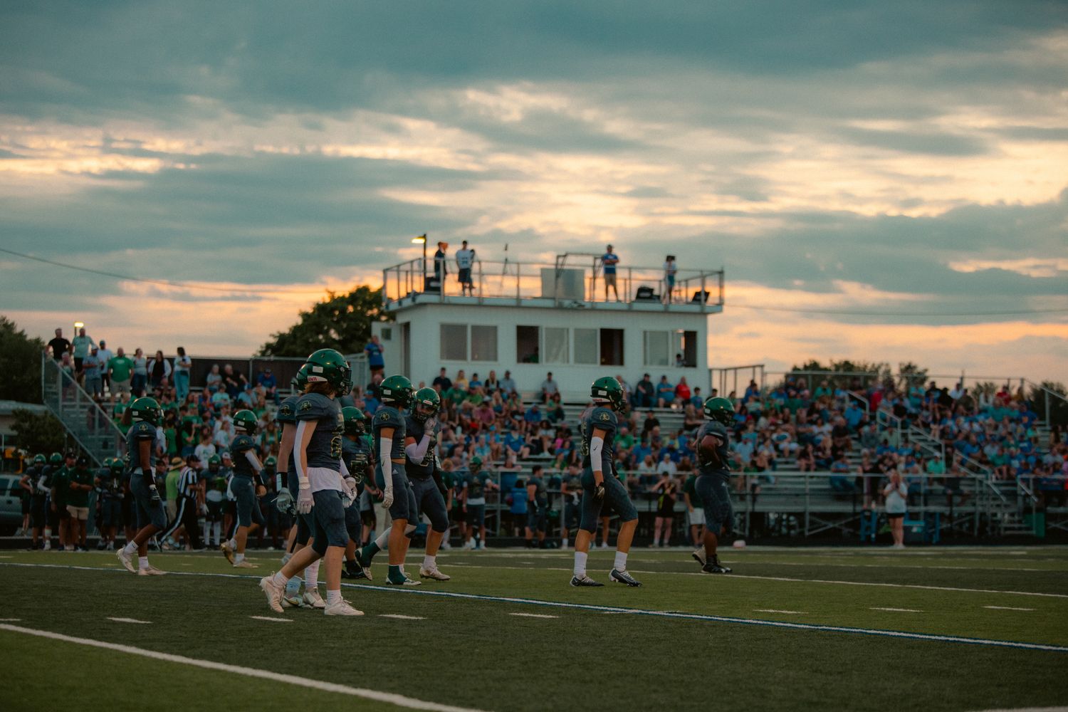 High school football goal posts on a field at night