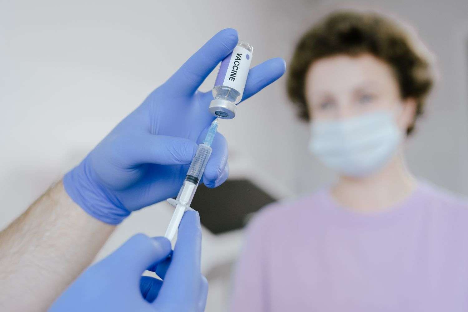 A health care worker preparing a vaccine