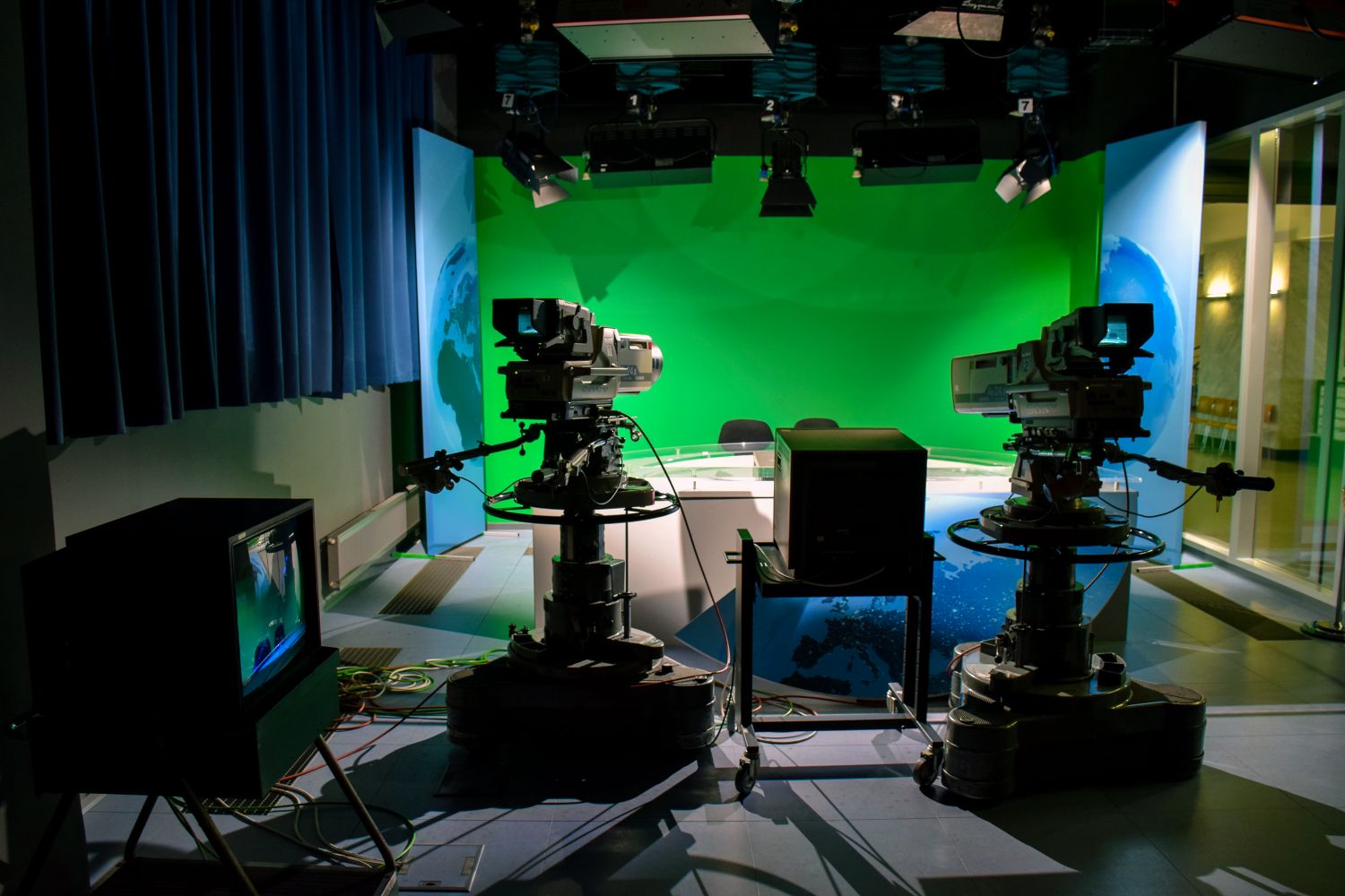 Television news studio with anchor desk and broadcast cameras