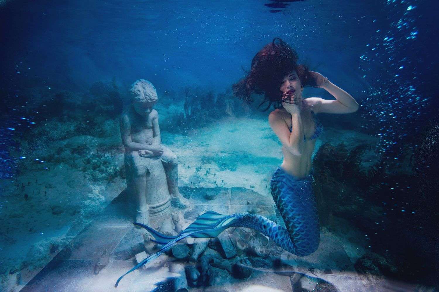 A welded metal mermaid sculpture designed as a water feature
