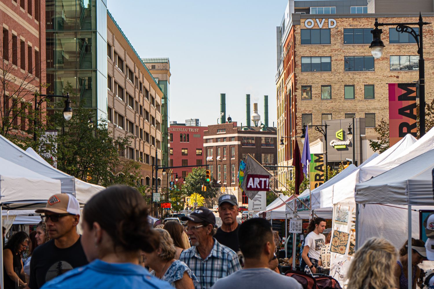 Visitors explore an outdoor arts festival in downtown Mobile