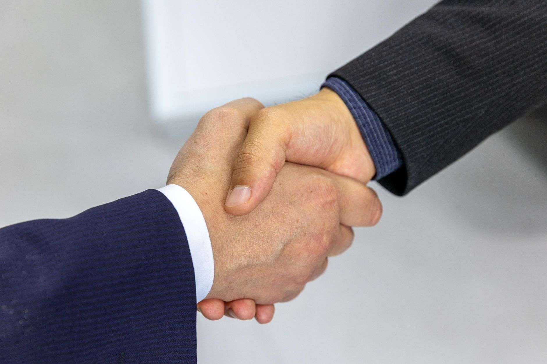 Business professionals shaking hands in an office setting