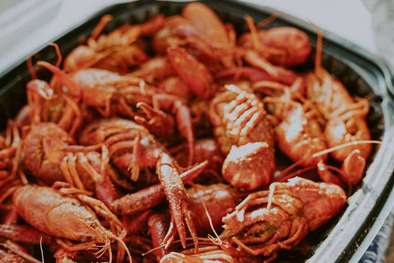 A pile of boiled crawfish with corn and potatoes