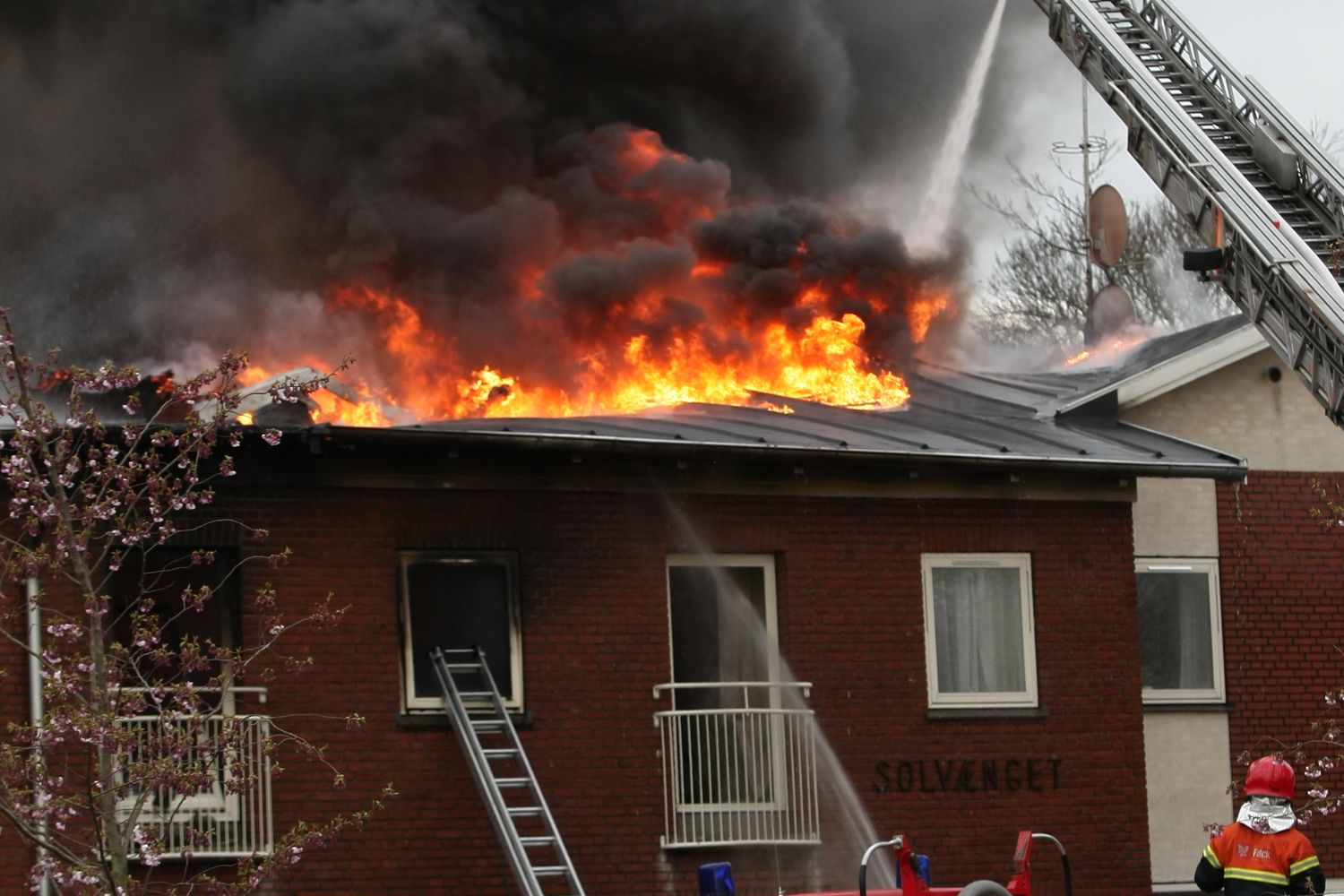 Firefighters at a residential house fire in Mobile at night
