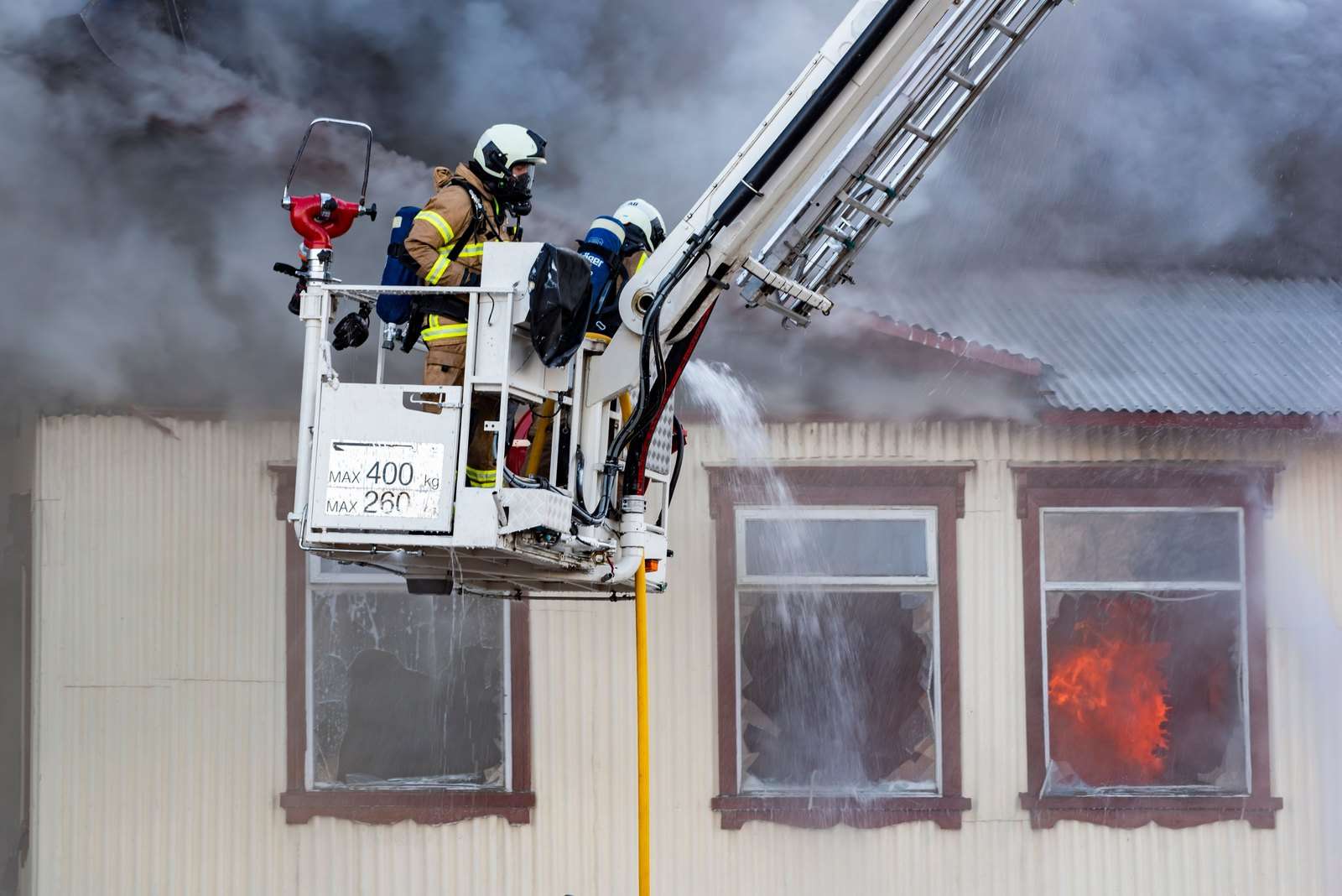 Firefighters work at the scene of a residential structure fire