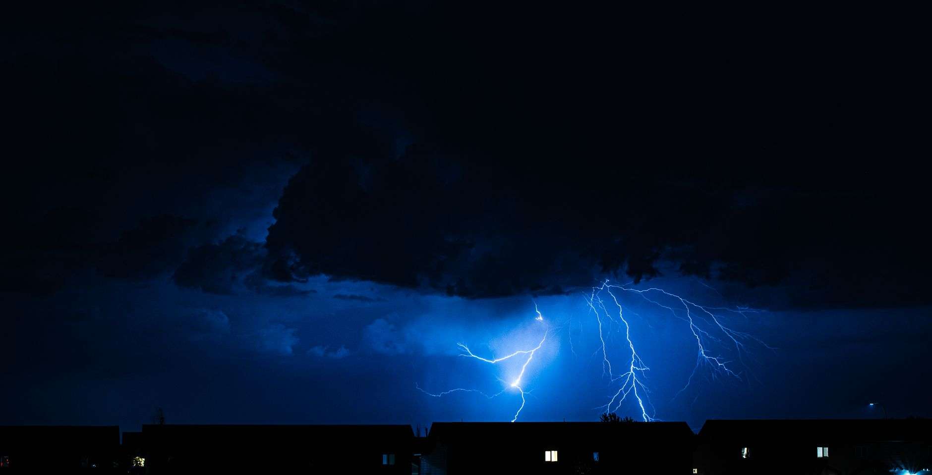 A bolt of lightning striking during a nighttime thunderstorm