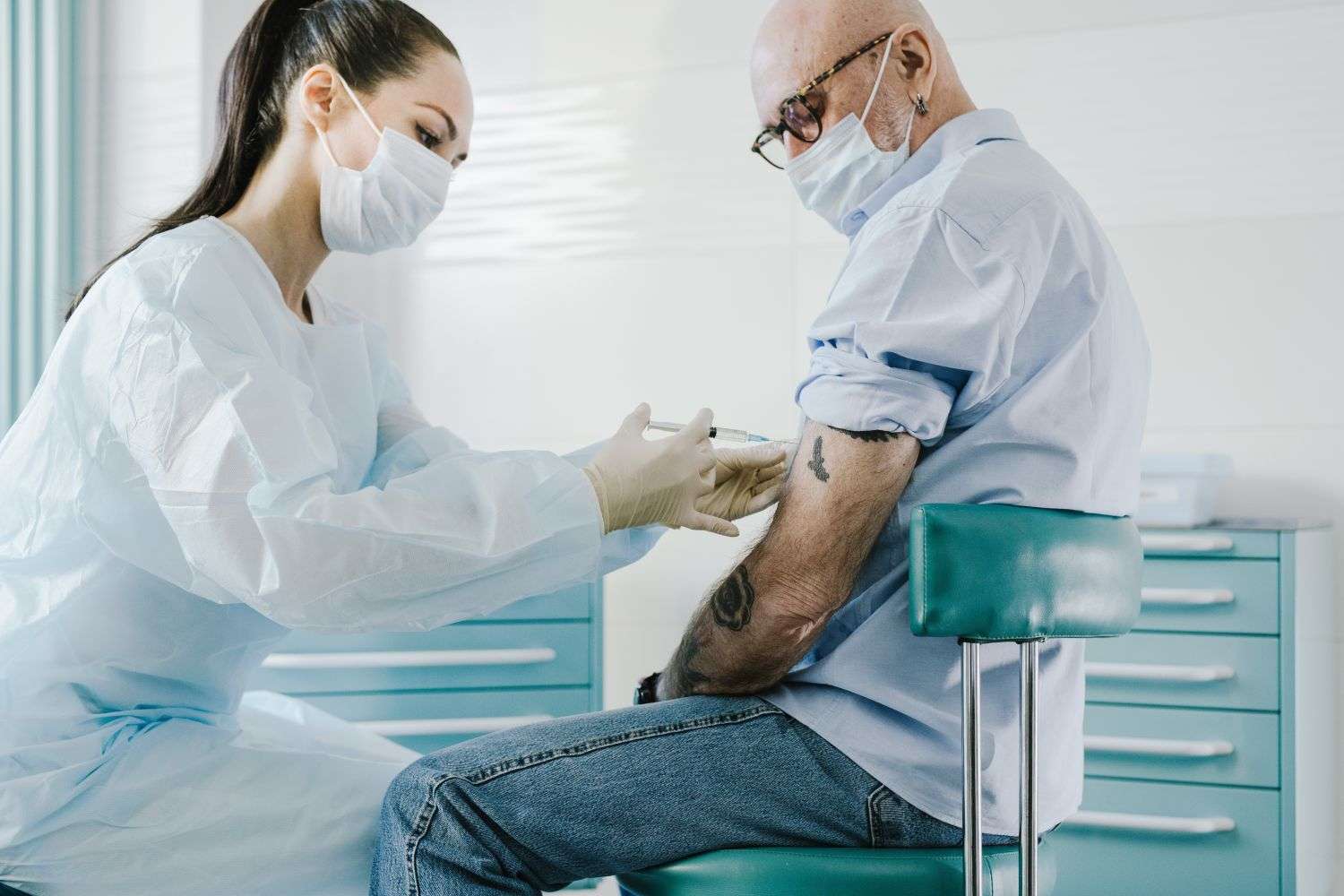 Health worker administering a vaccine to an older adult