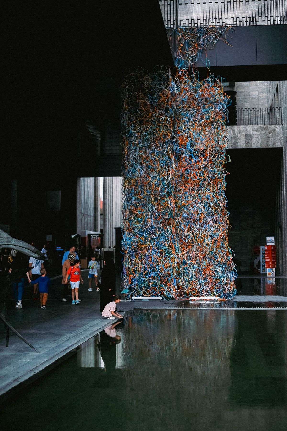 Visitors exploring artwork displayed in a contemporary museum gallery