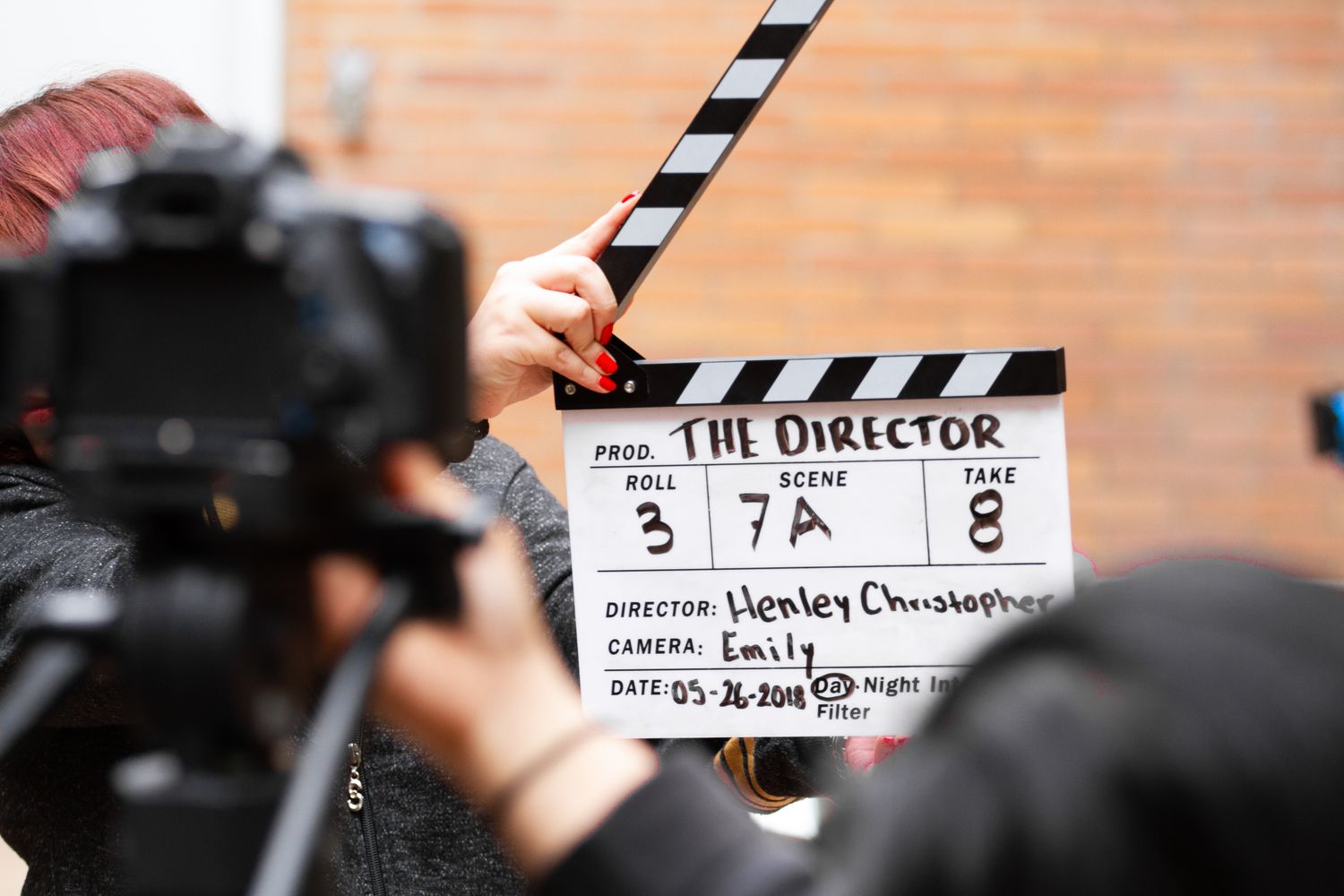Film clapperboard next to a video camera during taping