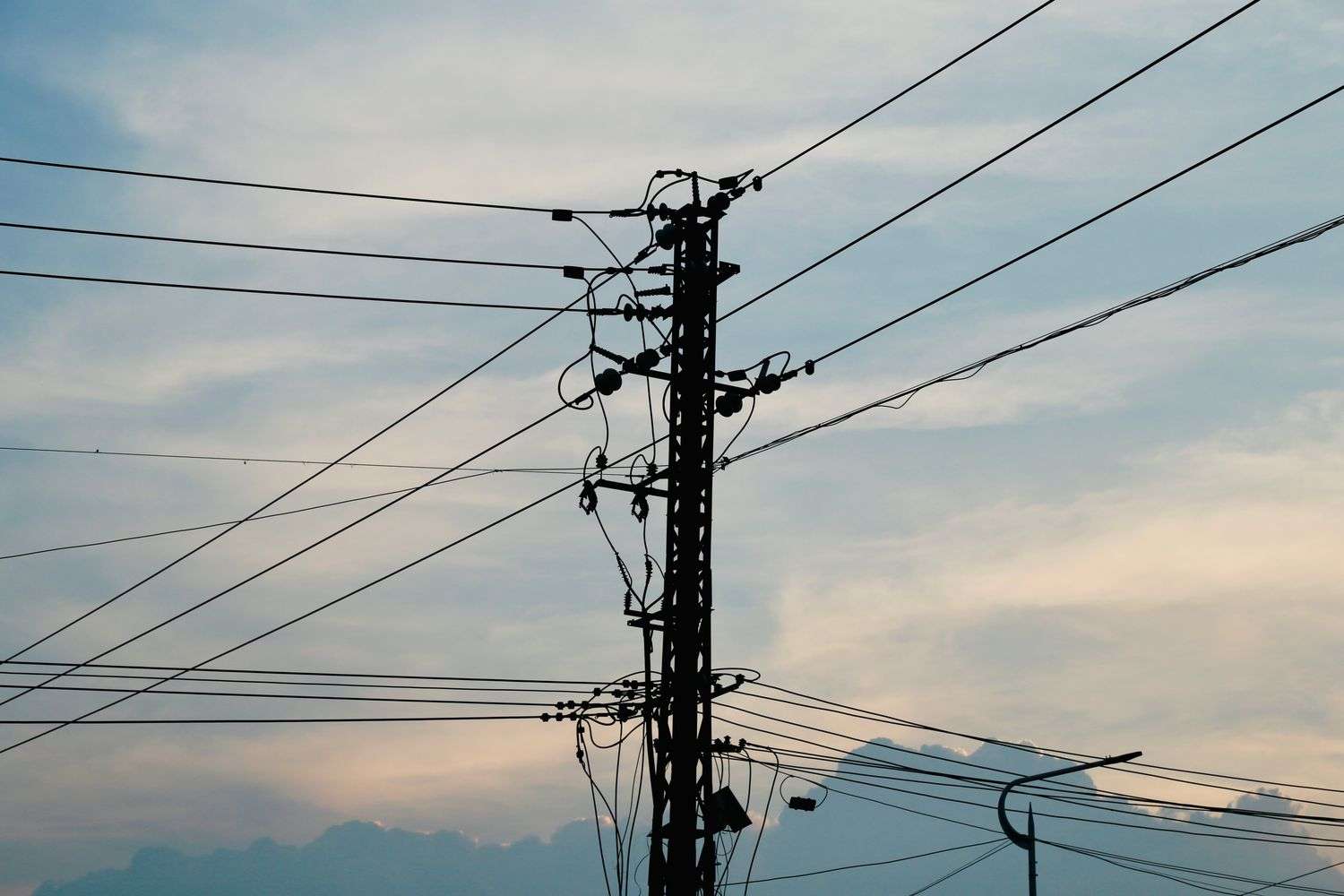 Power lines running along a wooden electric utility pole