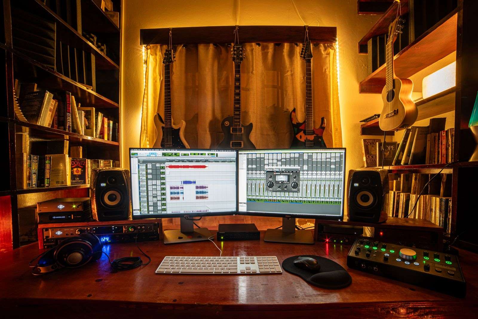 Home recording studio with guitars, monitors and audio equipment