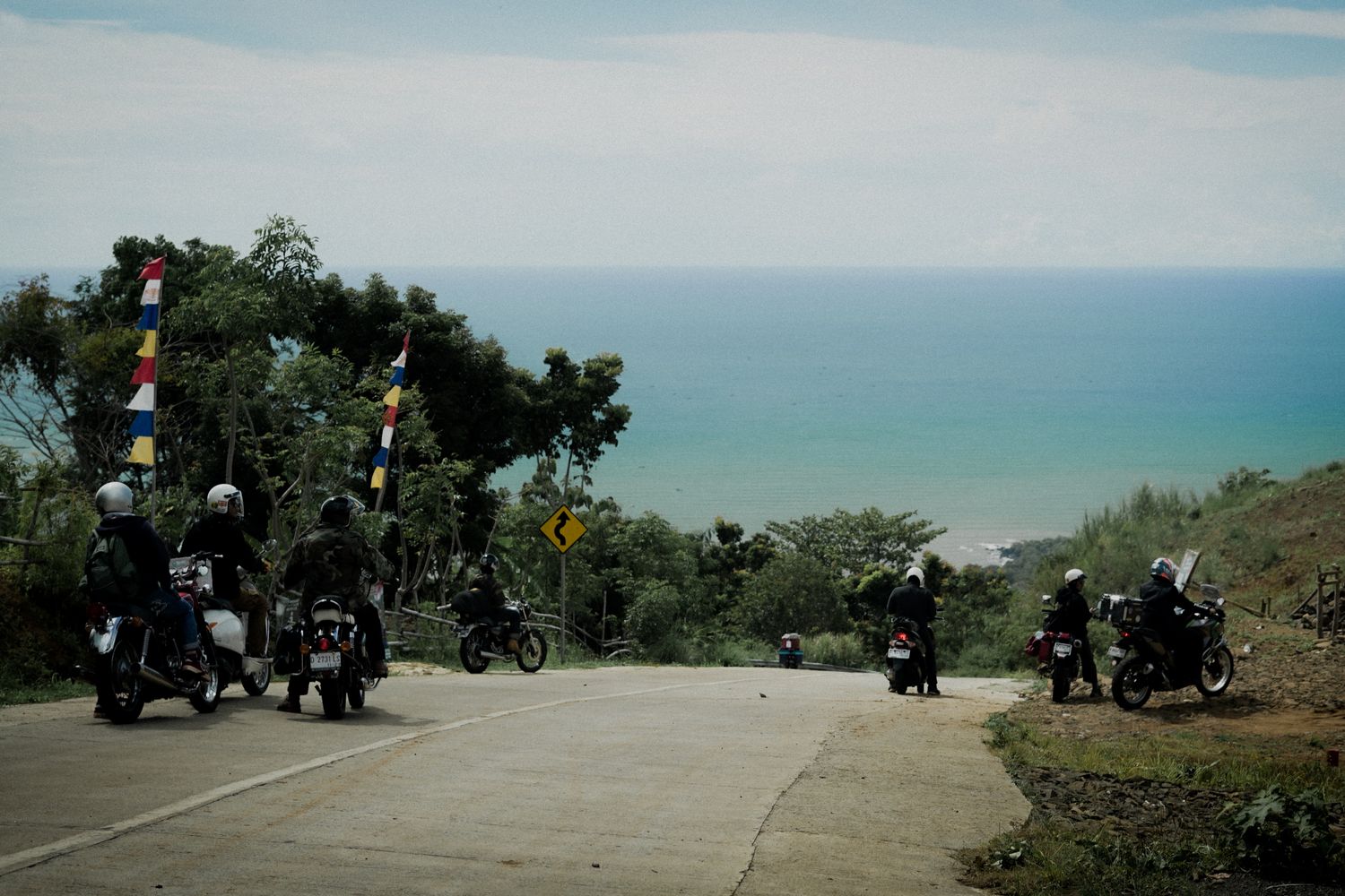 Group of motorcyclists riding down a scenic highway