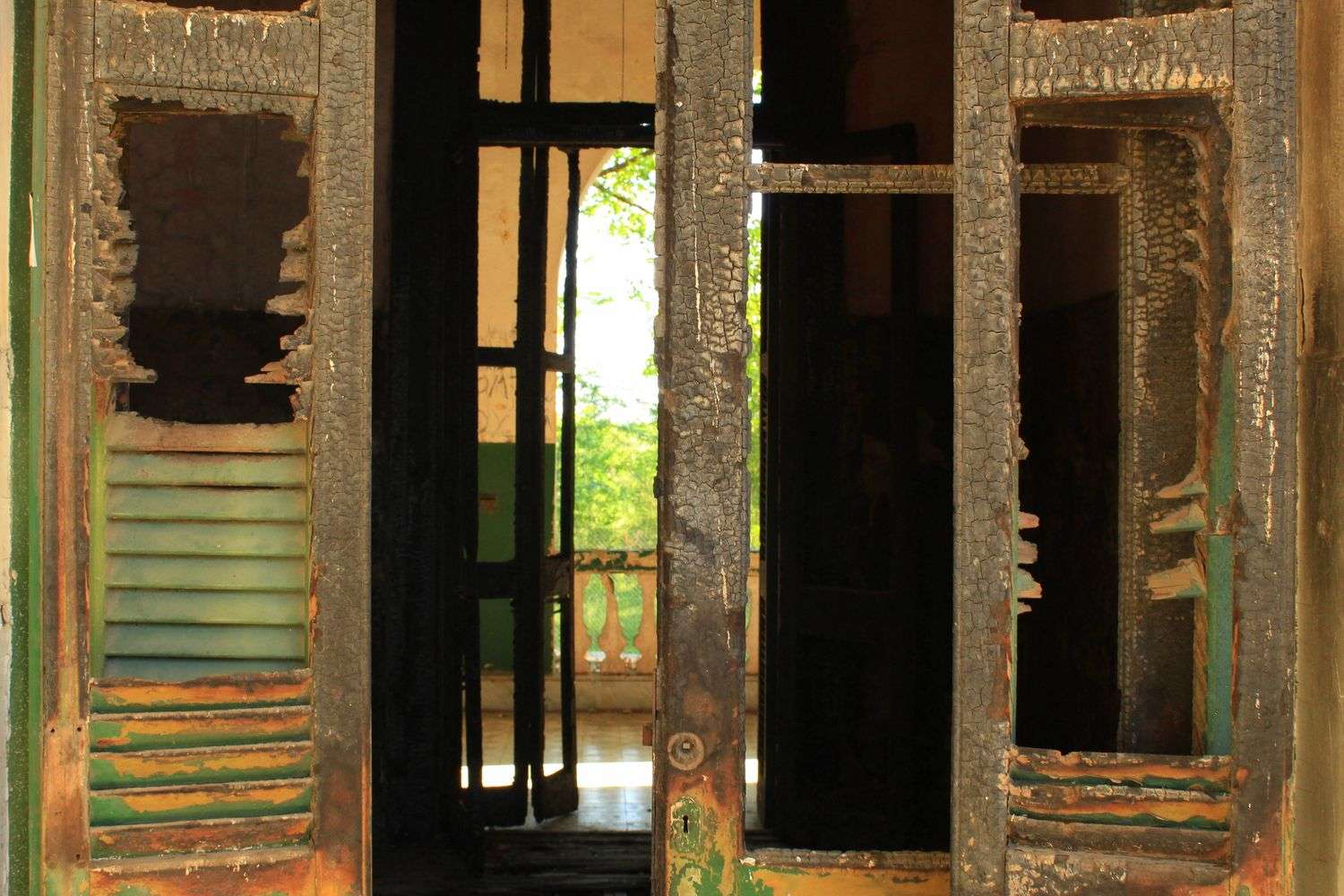 A charred apartment doorway with visible smoke damage