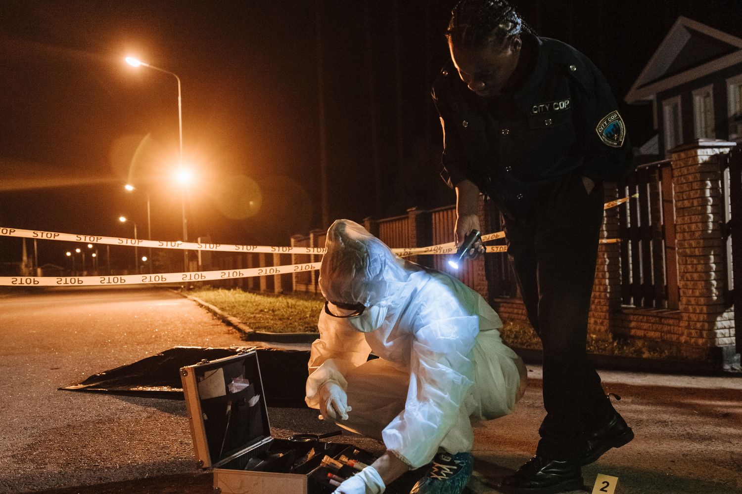 Police officers gathered at a residential street during an investigation