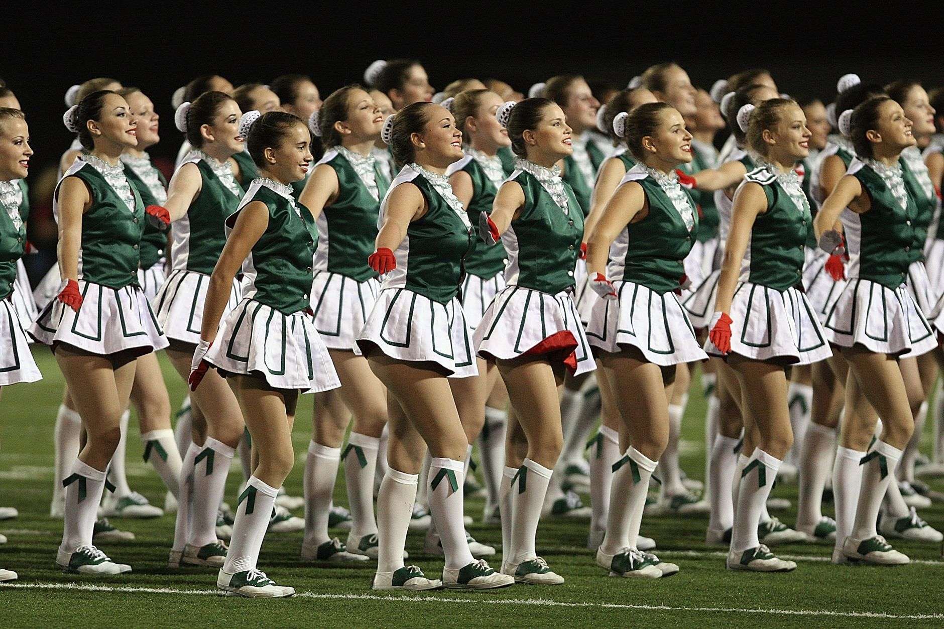 Crowd gathered at a high school football stadium for a pep rally