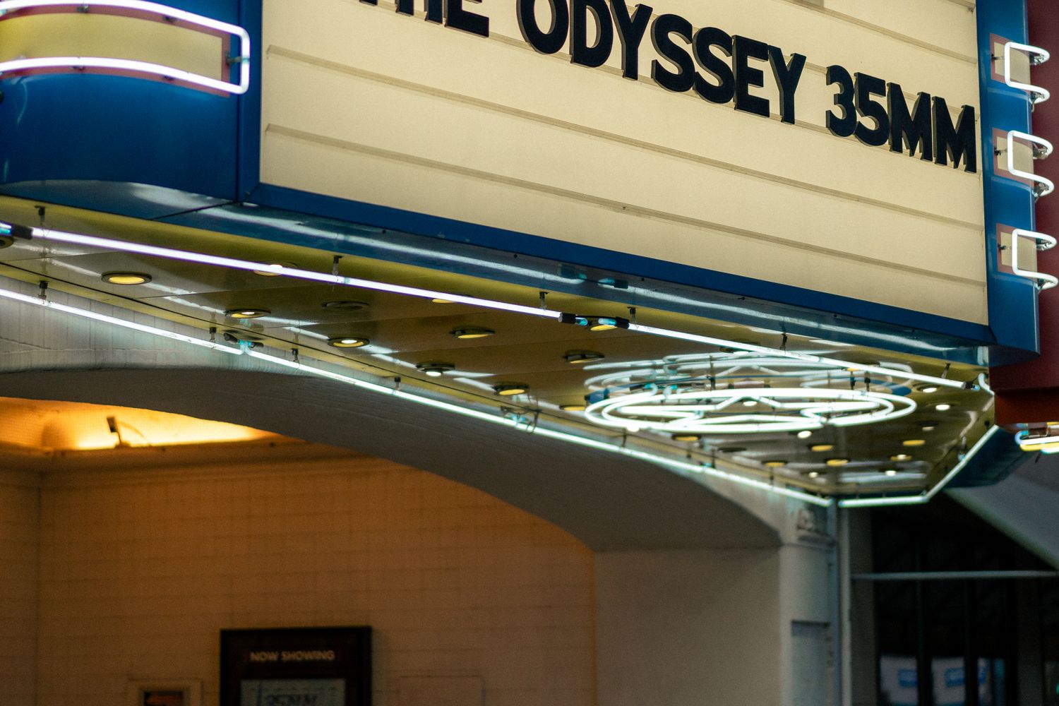 Movie theater marquee illuminated at night