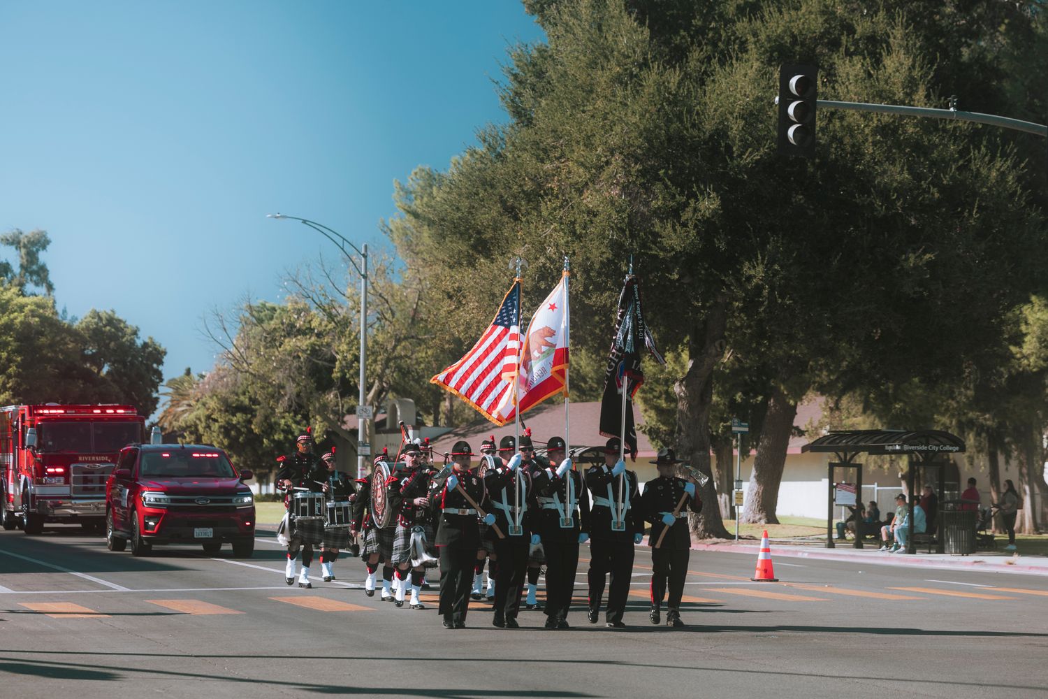 A procession of emergency vehicles honoring a fallen police officer on a Mobile highway