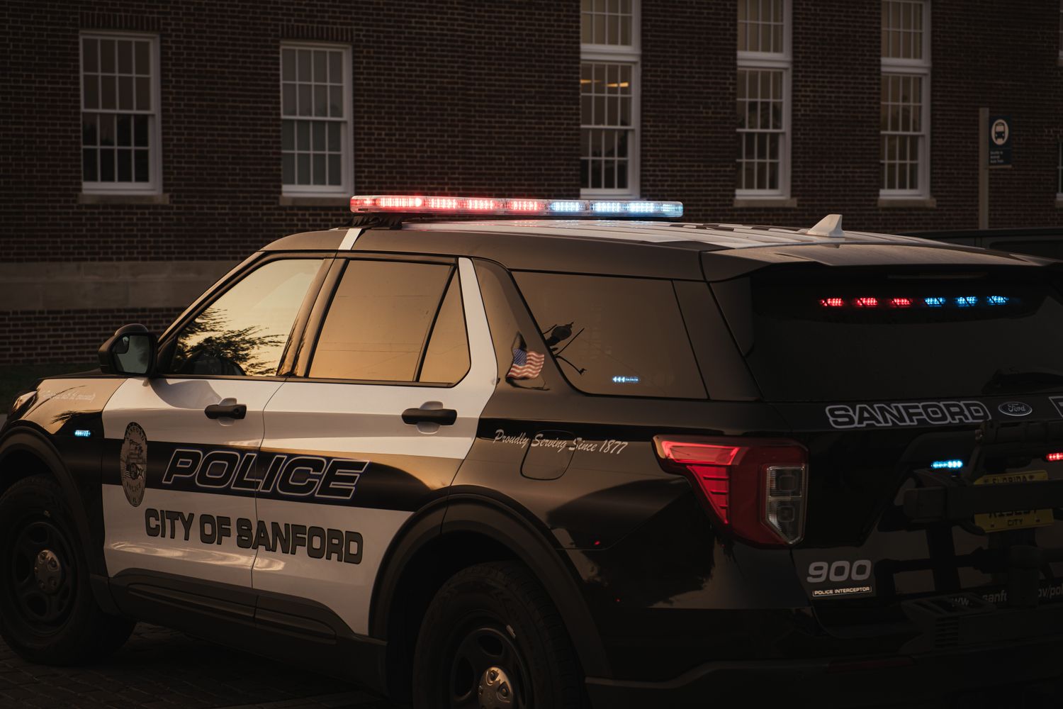 Row of police vehicles parked outside a law enforcement facility