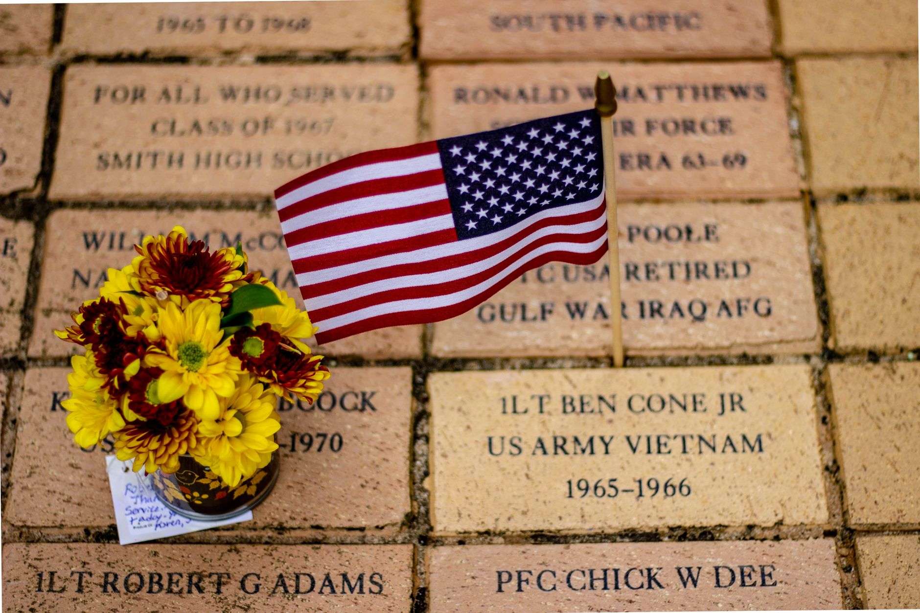 Engraved commemorative bricks laid out at a veterans memorial site