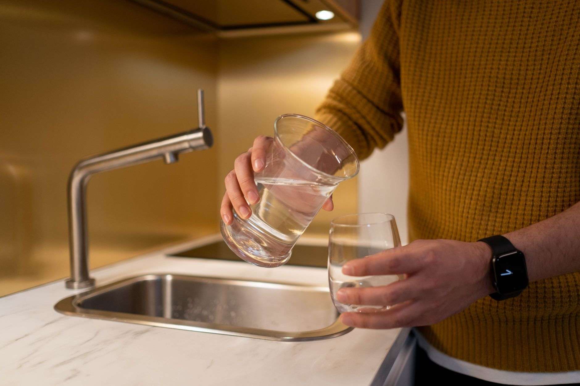 Clear water pouring from a faucet, representing a public water utility
