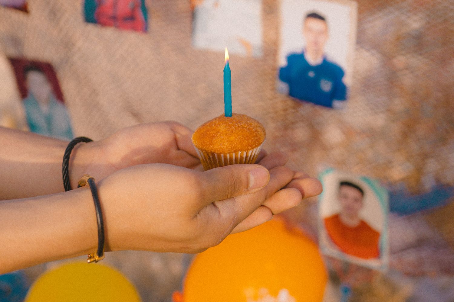 Candles and balloons at a roadside memorial