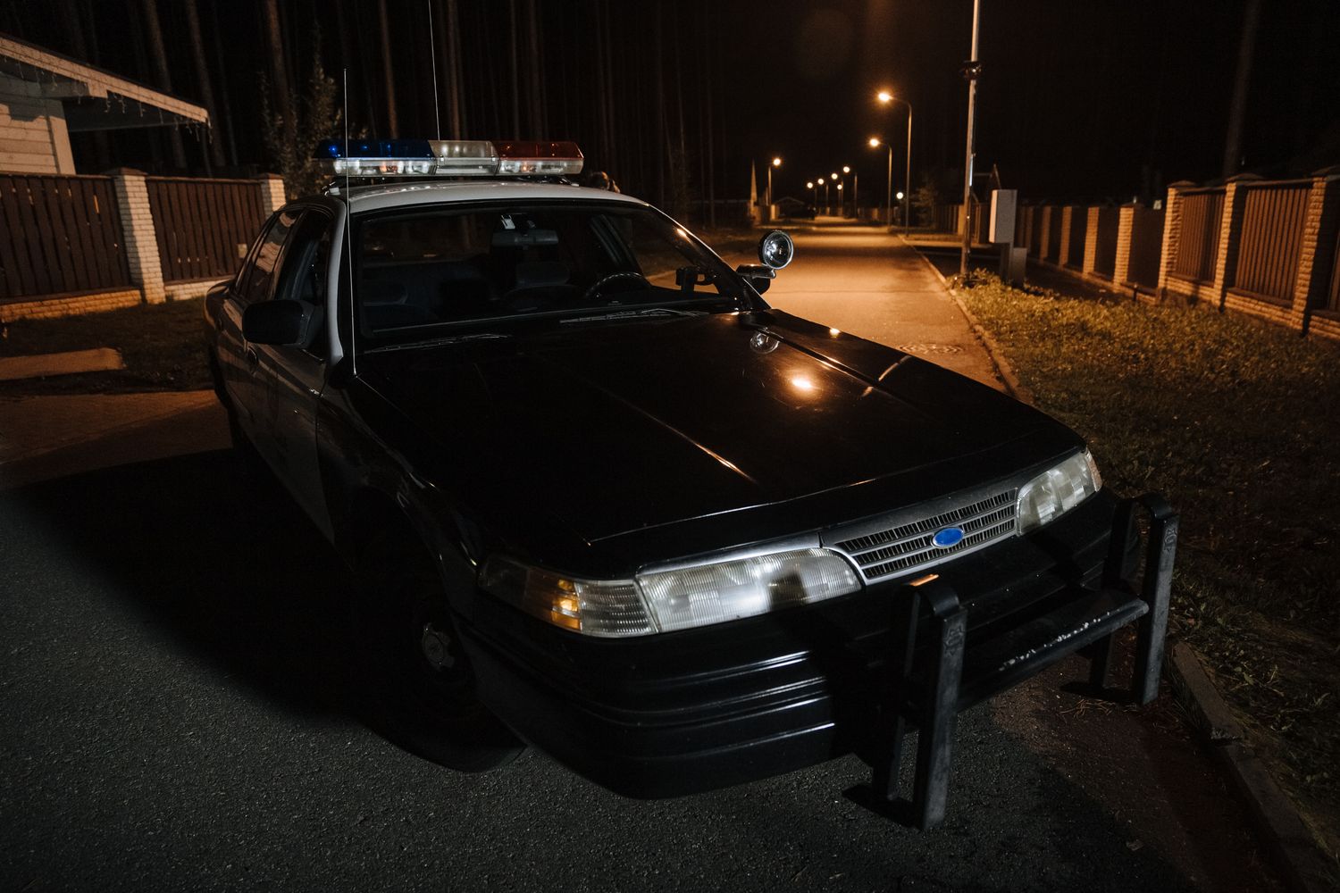 A law enforcement vehicle with flashing blue lights after dark
