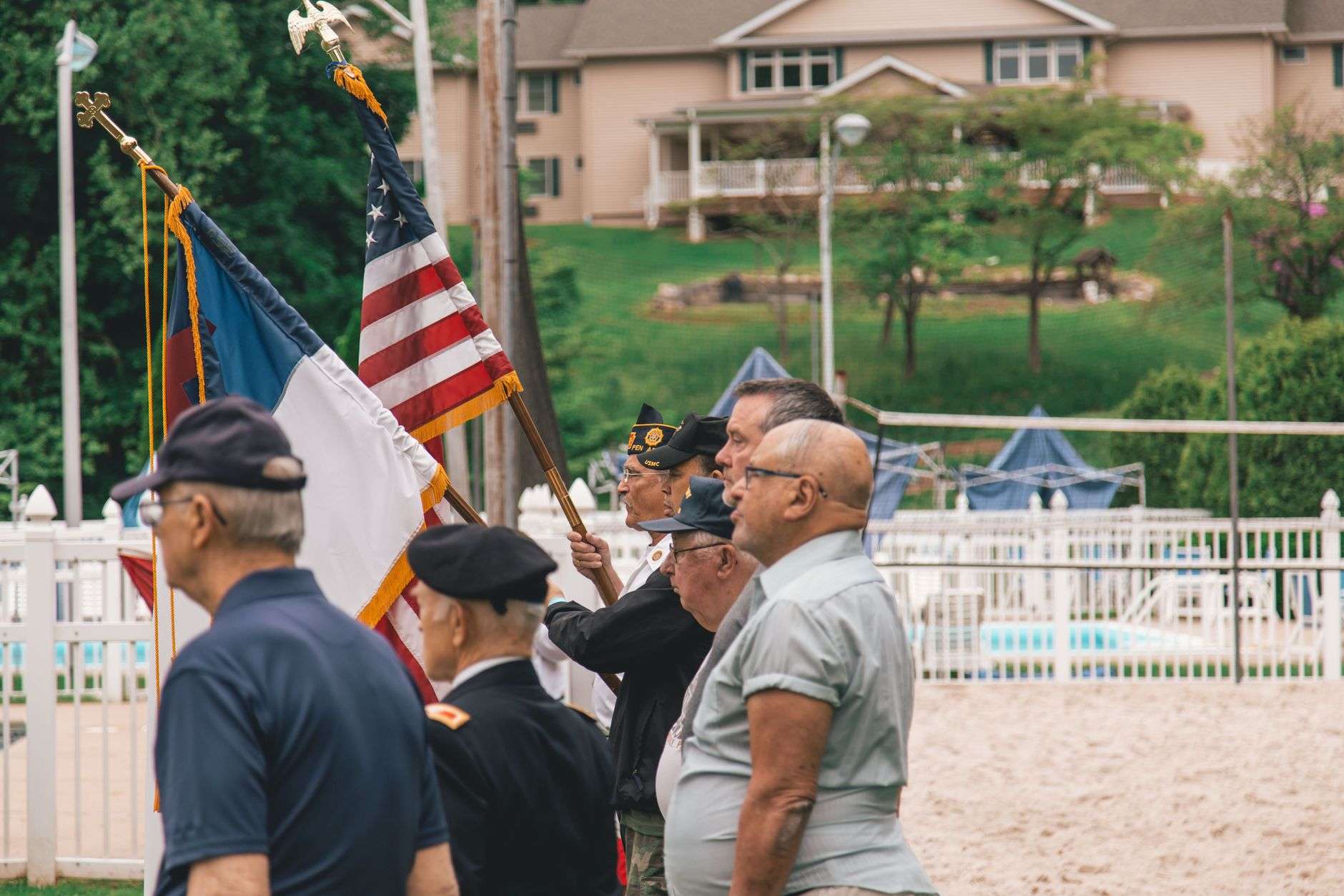 Veterans gathered at a military honors ceremony with American flags