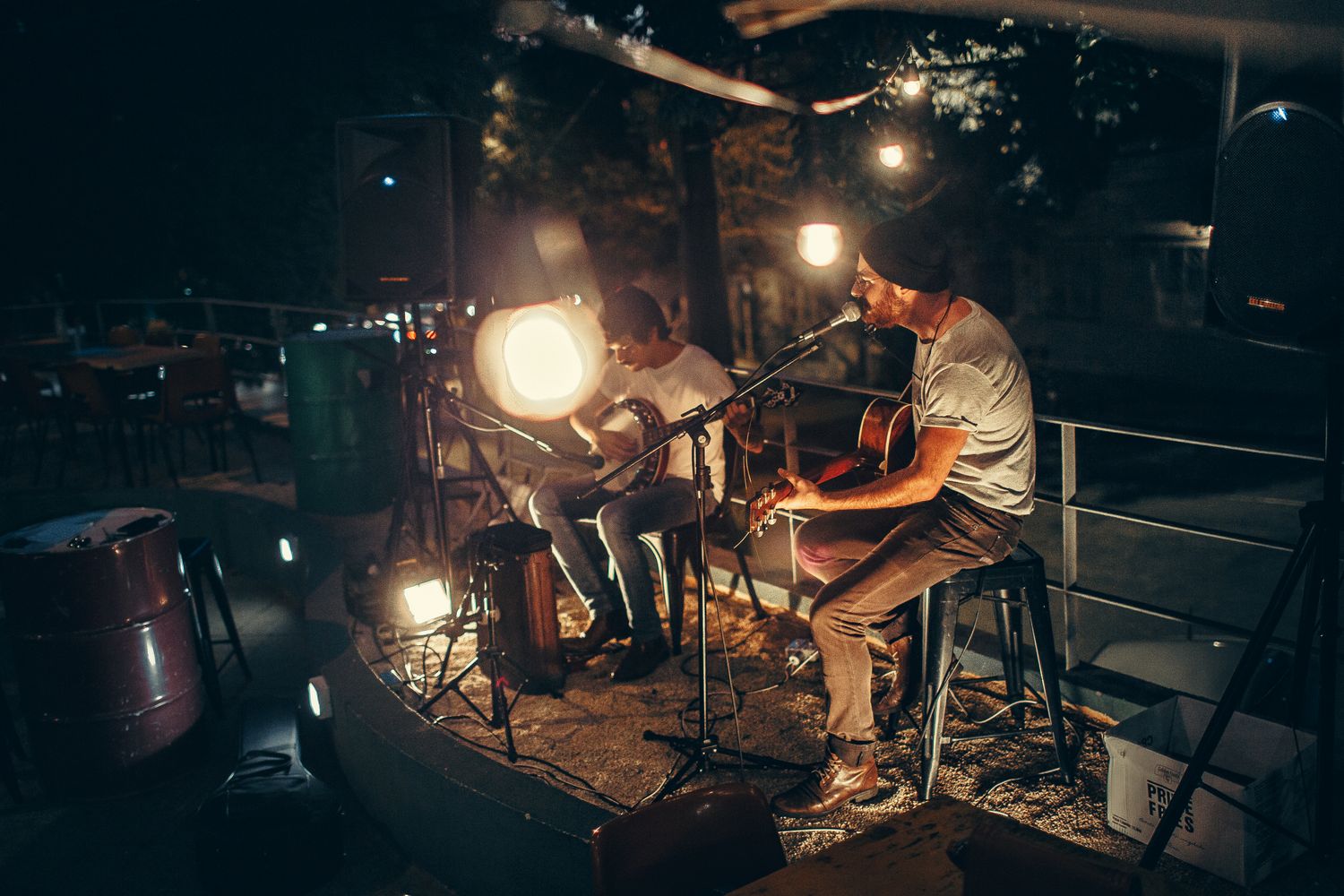 Musicians with guitars performing at a small venue