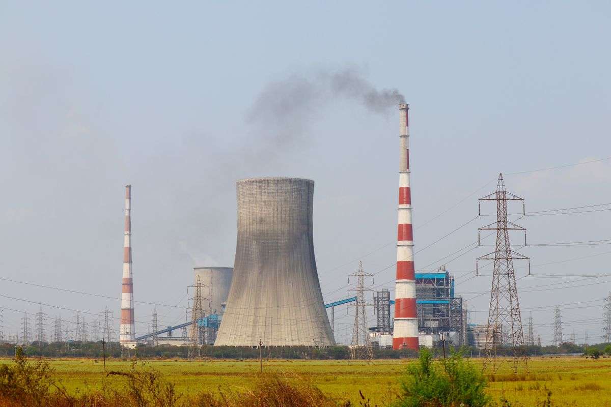 Coal-fired power plant with cooling towers and smokestacks representing Plant Barry in Mobile County