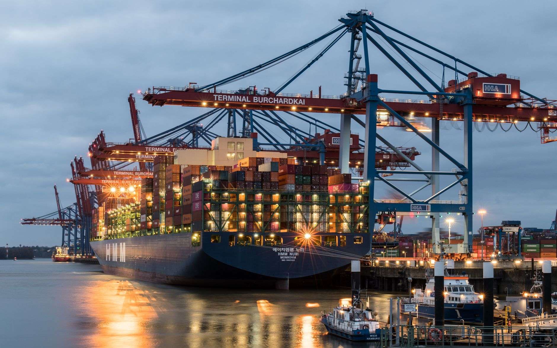 Cargo ship and shipping containers at a busy port